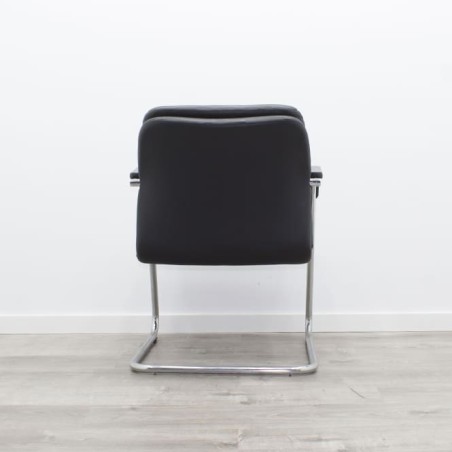 Silla confidente en piel con brazos y base patín